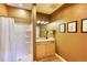 Small bathroom with shower, granite countertop, and light wood cabinets at 5236 Bear Mountain Dr, Evergreen, CO 80439