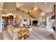 Spacious living room features high ceilings, a cozy sitting area, and views into the kitchen at 5236 Bear Mountain Dr, Evergreen, CO 80439