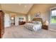 Main bedroom features high ceilings, ample space, and views of the surrounding landscape at 5236 Bear Mountain Dr, Evergreen, CO 80439