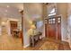 Bright entryway with a view into the kitchen and a hardwood floor at 5236 Bear Mountain Dr, Evergreen, CO 80439