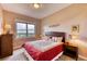 Bright bedroom with a king-size bed and views of trees at 5236 Bear Mountain Dr, Evergreen, CO 80439