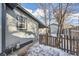 Side yard view with detached garage and wooden fence at 2360 S Franklin St, Denver, CO 80210