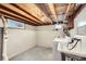 Unfinished basement laundry area with washer, dryer, and sink at 2360 S Franklin St, Denver, CO 80210