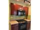 Kitchen boasting dark wood cabinets and a black stovetop at 2213 S Kingston Ct, Aurora, CO 80014