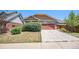 Ranch-style home with stone and siding accents, two-car garage, and well-maintained lawn at 148 N Irvington St, Aurora, CO 80018