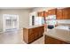 Kitchen with island, wood cabinets, and door to backyard at 148 N Irvington St, Aurora, CO 80018
