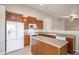 Eat-in kitchen with white appliances and wood cabinetry at 148 N Irvington St, Aurora, CO 80018