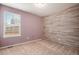 Bedroom with light purple walls, wood-look accent wall, and carpet at 148 N Irvington St, Aurora, CO 80018