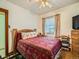 Bedroom with wood bed frame, dresser, and southwestern bedding at 5960 Glencoe St, Commerce City, CO 80022