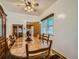 Dining room with wood table, chairs, and a view to kitchen at 5960 Glencoe St, Commerce City, CO 80022