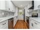 Modern kitchen with white cabinets, quartz countertops, and stainless steel appliances at 4195 S Lipan St, Englewood, CO 80110