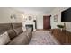 Living room with brown couch, fireplace, and wooden cabinet at 1111 Elysian Field Dr # D, Lafayette, CO 80026