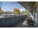Private deck with table and chairs, overlooking a tree-lined area at 1111 Elysian Field Dr # D, Lafayette, CO 80026