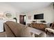 Living room with brown couch, fireplace, and wooden cabinet at 1111 Elysian Field Dr # D, Lafayette, CO 80026