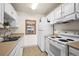 Bright kitchen features white cabinetry, modern appliances, and double sink at 1111 Elysian Field Dr # D, Lafayette, CO 80026