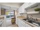 Kitchen with view into dining area and access to a patio at 1111 Elysian Field Dr # D, Lafayette, CO 80026