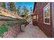 Brick pathway leads to backyard with mountain views at 6994 Sprucedale Park Way, Evergreen, CO 80439