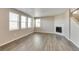 Bright living room featuring hardwood floors and a corner fireplace at 18279 Field Mint Pt, Parker, CO 80134