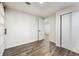 Simple bedroom with hardwood floors and barn door at 1155 Meadow St, Longmont, CO 80501