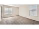 Well-lit bedroom with two windows and carpet flooring at 20000 E Mitchell Pl # 4, Denver, CO 80249