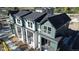 Aerial view of three townhomes with dark roofs at 11964 W 57Th Dr, Arvada, CO 80002