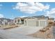 Gray craftsman style home with three-car garage and landscaping at 1094 Rambling Oak Dr, Monument, CO 80132