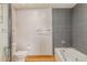 Bathroom with shower, bathtub, and gray tile at 1020 15Th St # 202, Denver, CO 80202