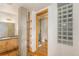 Bathroom with glass block feature wall and a walk-in shower at 1020 15Th St # 202, Denver, CO 80202