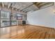 Open living area with hardwood floors and exposed beams at 1020 15Th St # 202, Denver, CO 80202