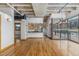 Open living room with hardwood floors and modern kitchen at 1020 15Th St # 202, Denver, CO 80202