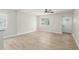 Bright living room with light wood-look flooring and neutral walls at 118 S Dale Ct, Denver, CO 80219