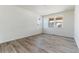 Bright and airy living room with wood-look floors at 3180 Boral Owl Dr, Brighton, CO 80601