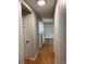 Hallway with hardwood floors and access to laundry and kitchen at 14602 E 2Nd Ave # 109C, Aurora, CO 80011