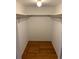 Large walk-in closet with wood flooring and overhead shelving at 14602 E 2Nd Ave # 109C, Aurora, CO 80011