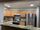 Kitchen with stainless steel appliances and wood cabinets at 14602 E 2Nd Ave # 109C, Aurora, CO 80011