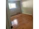 Bright bedroom with hardwood floors and large window at 14602 E 2Nd Ave # 109C, Aurora, CO 80011