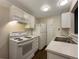 Clean kitchen with white appliances and cabinets at 6705 S Field St # 803, Littleton, CO 80128