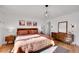 Spacious bedroom with wood furniture and a large mirror at 637 S Cole Ct, Lakewood, CO 80228