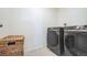 Laundry room with modern washer and dryer at 4983 Trails Edge Ln, Castle Rock, CO 80104