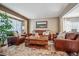 Cozy living room featuring leather sofas and a coffee table at 10185 Silver Maple Cir, Highlands Ranch, CO 80129