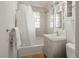 Clean bathroom with updated vanity and shower/tub combo at 1575 S Clermont St, Denver, CO 80222