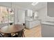 Bright kitchen with white cabinets, granite countertops and eat-in area at 1575 S Clermont St, Denver, CO 80222