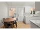 Kitchen boasts white cabinets, granite counters, and eat-in area at 1575 S Clermont St, Denver, CO 80222