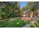 Spacious backyard with patio, mature trees, and plenty of space for outdoor activities at 1575 S Clermont St, Denver, CO 80222