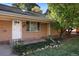 Charming ranch home with brick exterior, front porch, and well-manicured landscaping at 1575 S Clermont St, Denver, CO 80222