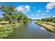 Serene river view with lush green vegetation at 2144 Alyssa St, Fort Lupton, CO 80621