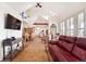 Spacious living room with vaulted ceiling, hardwood floors, and a view into the kitchen at 6317 County Road 41, Fort Lupton, CO 80621