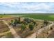 Wide shot of property showing house, outbuildings and surrounding land at 6317 County Road 41, Fort Lupton, CO 80621