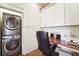 Laundry room with washer, dryer, and built-in desk at 6317 County Road 41, Fort Lupton, CO 80621