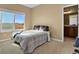 Cozy bedroom with full-size bed, window seat, and access to bathroom at 28525 Pike View Farm Cir, Elizabeth, CO 80107